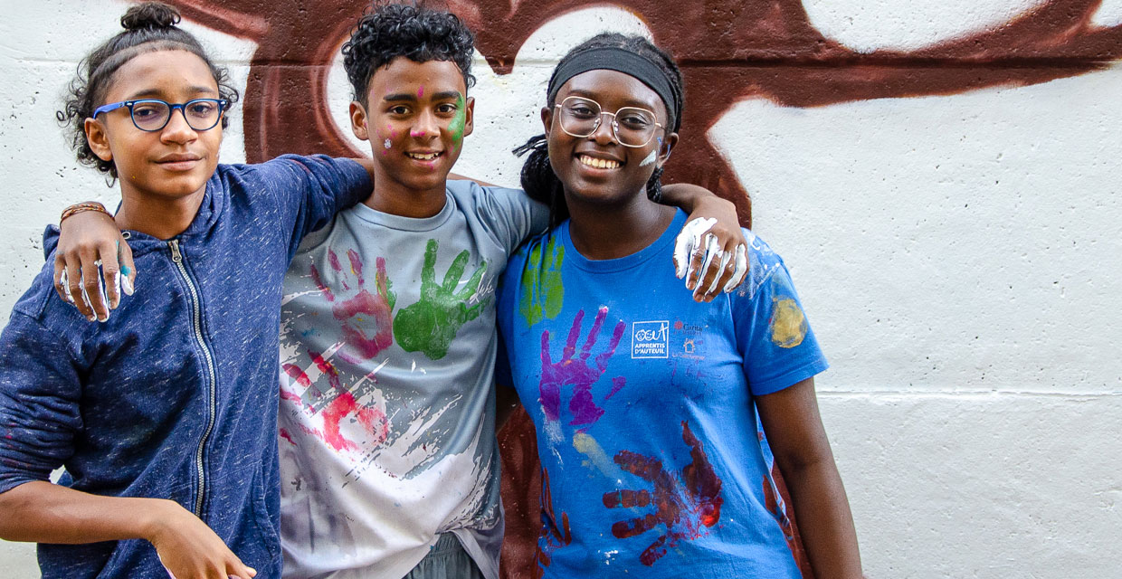 Evans, Nigel et Paris posant devant l'arbre peint sur la fresque