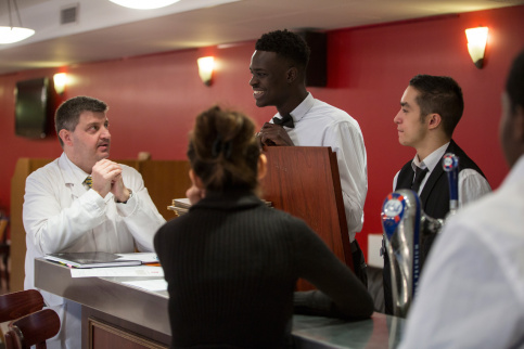 M. Falières, professeur de salle, fait le point avec les élèves avant le service.