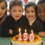 Les enfants soufflent les bougies du gâteau du 150ème anniversaire d'Apprentis d'Auteuil